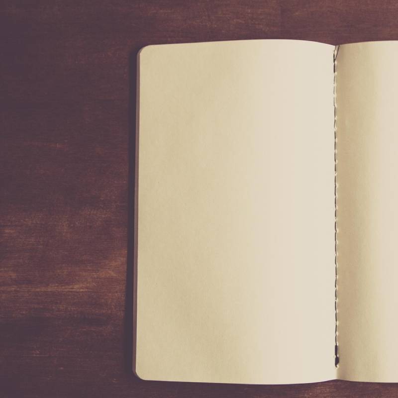 Notebook open on blank page waiting for your ideas, images and inspired creative writing.