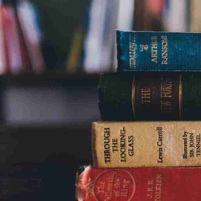 Classic leatherbound novels in a stack: Tolkein, Lewis Carroll and Arthur Ransome.