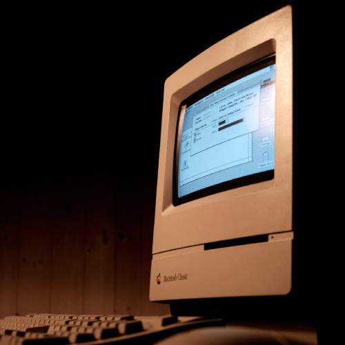 Clunky old model of a desktop Macintosh computer looming out of the dark, there to ironically ask the question being posed by Gail Owen writer, can such a machine ever be conscious?